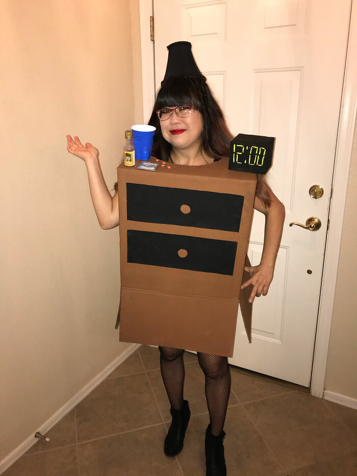 Woman in a creative Halloween costume made from cardboard, showing a simple and effective effort in DIY Halloween costumes.