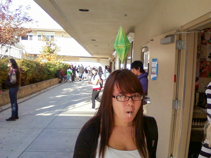Person wearing a simple costume with a green plumbob prop, representing a character with minimal effort Halloween costume idea.