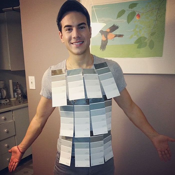 Man wearing a creative Halloween costume made of paint sample cards, showcasing easy and great Halloween costume ideas.