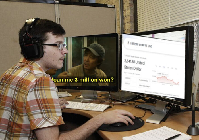 Person at a desk viewing a Squid Game meme on one screen and currency conversion on another.