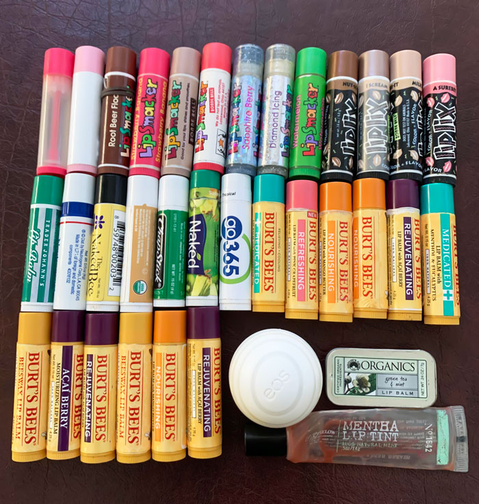 Assorted lip balms and chapsticks from the 2000s era, featuring nostalgic and popular brands.