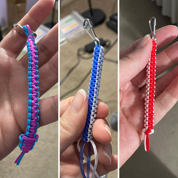Three colorful lanyards, popular 2000s crafts, held in hands.