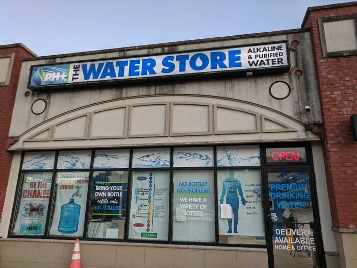 Storefront of The Water Store featuring signs about alkaline and purified water.