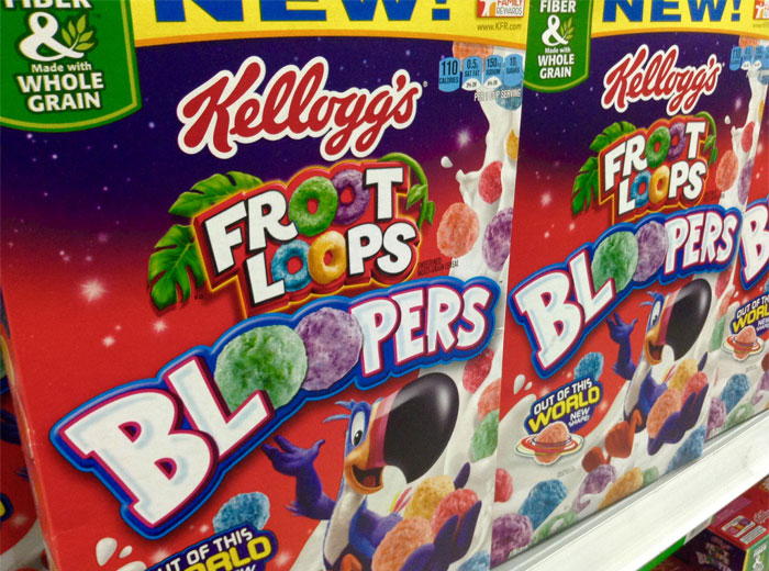 Kellogg's Froot Loops cereal boxes on store shelf with colorful branding and mascot, illustrating famous brands sarcastic slogans.