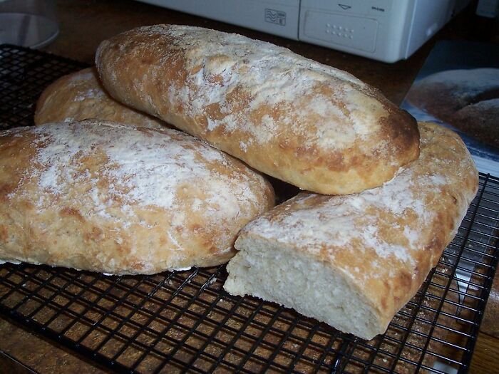 Freshly baked homemade bread loaves cooling on a wire rack, a product completely worth your money for quality and taste.