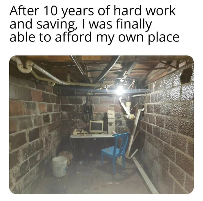 A shabby basement room with old computer and chair, illustrating a struggling renter facing greedy landlord issues.