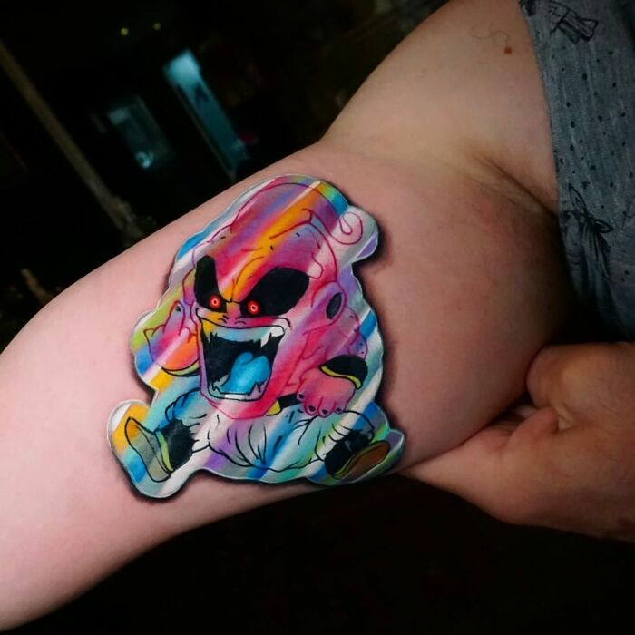 Tattoo resembling a holographic sticker on arm, featuring a colorful animated character with vivid details.