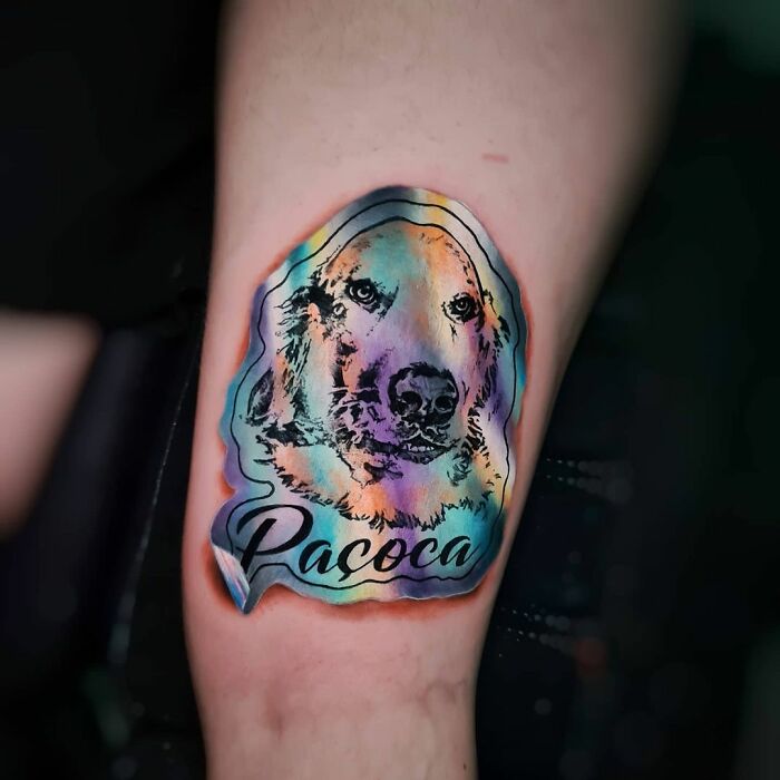 Holographic sticker tattoo of a dog named Pacoca, created by a Brazilian artist, on a person's skin.
