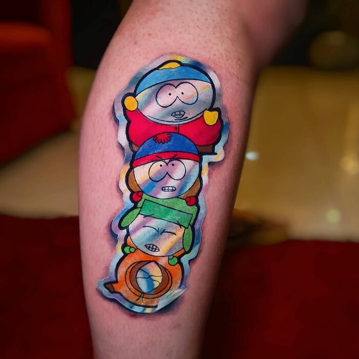 Holographic sticker tattoo on leg with vibrant colors reflecting South Park characters.