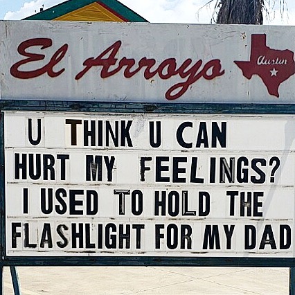 Humorous restaurant sign reads: "U THINK U CAN HURT MY FEELINGS? I USED TO HOLD THE FLASHLIGHT FOR MY DAD."