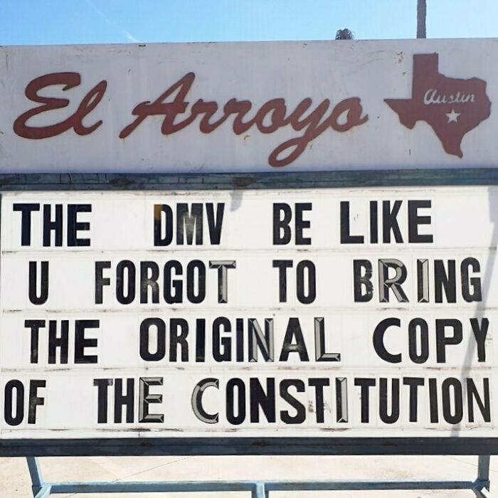 Restaurant sign with humorous message about the DMV requiring the original copy of the Constitution.