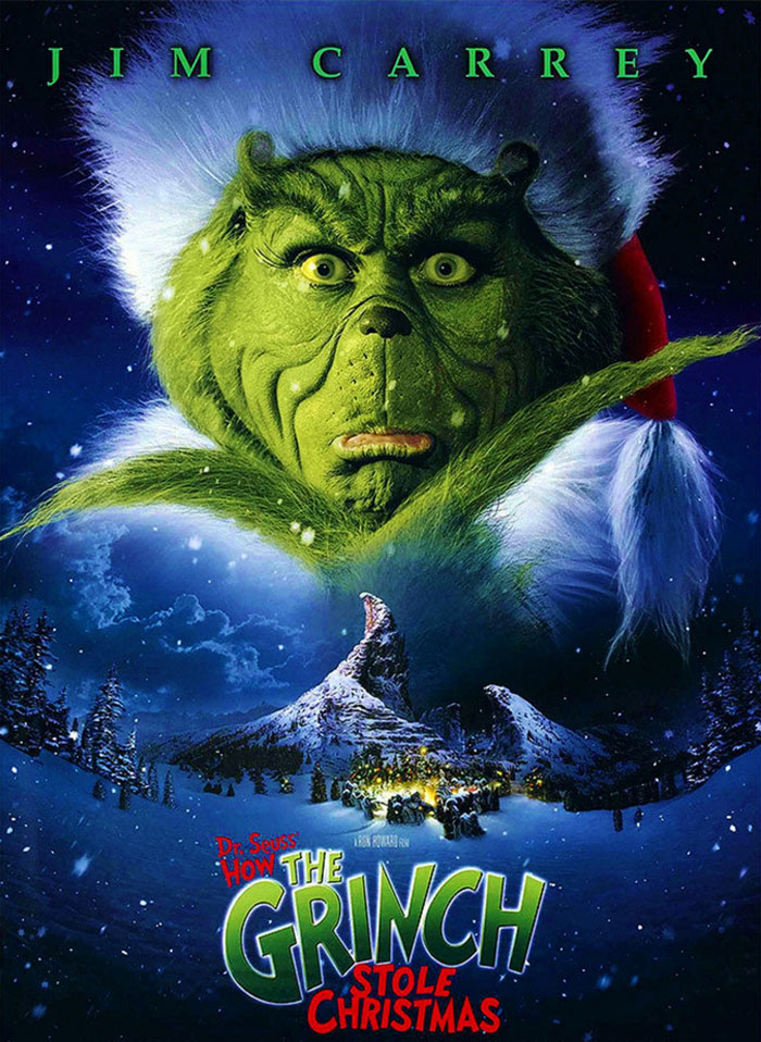 Poster of "How The Grinch Stole Christmas" with a snowy mountain and the Grinch's face in the sky.
