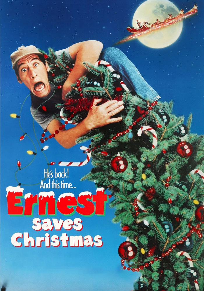 Man clinging to Christmas tree with Santa flying past the moon in "Ernest Saves Christmas" movie poster.