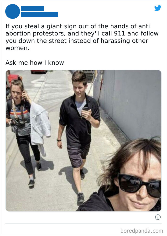 Three people walking on a sunny sidewalk, captured in a chaotic good action moment from an online group post.