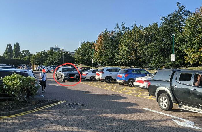 Parking lot with cars in no-parking zones, showing chaotic good actions captured by an online group dedicated to unusual behavior.