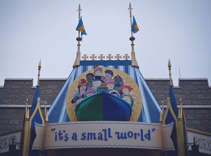 Signage of the "it's a small world" ride at Disney theme park, reflecting employee experiences and opinions.