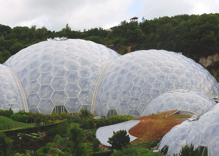Large hexagonal dome structures surrounded by greenery, representing Disney theme park employees' work environment.