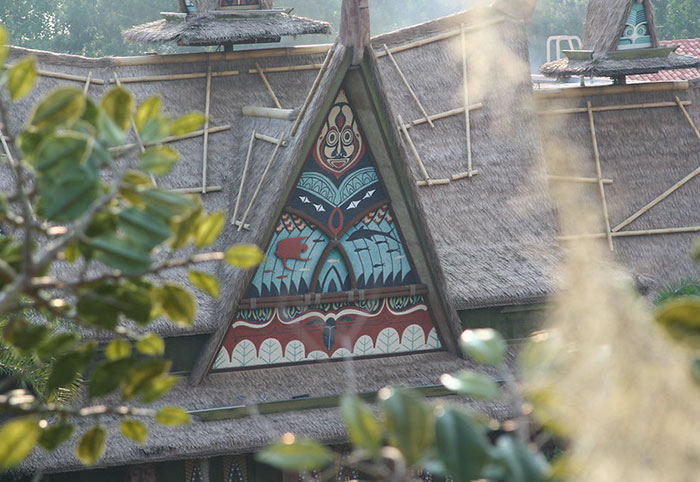 Thatched roof building with tribal design details representing Disney theme park employees' work environment.