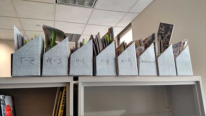 File organizers labeled with letters holding papers on a shelf, symbolizing life stories of people labeled gifted.
