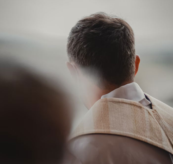 Man seen from behind quietly reflecting, symbolizing good deeds people have been keeping in secret.
