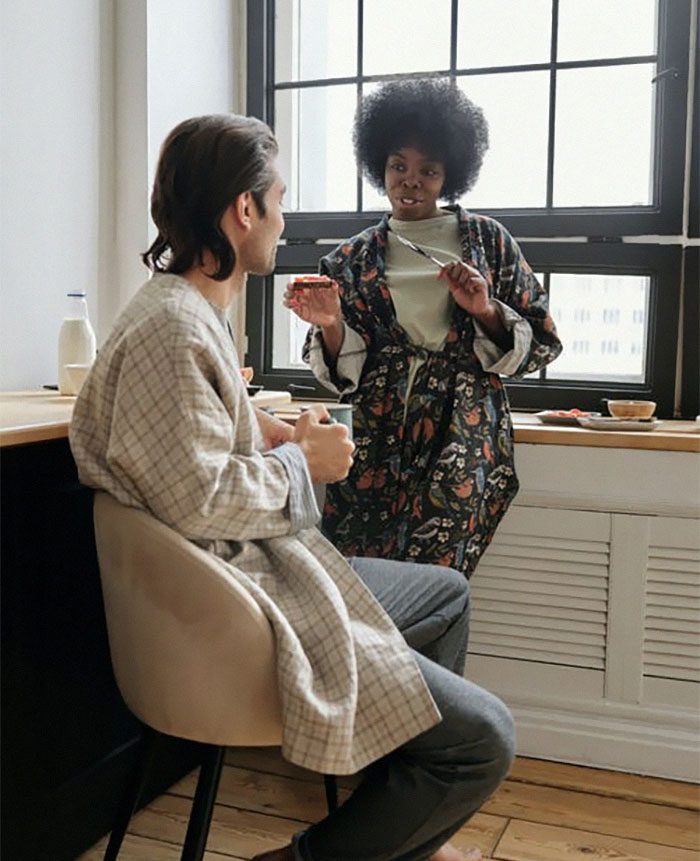 Couple having a relaxed conversation in a bright kitchen, sharing insights about married life and relationships.