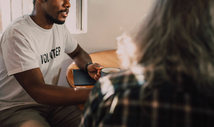 Two people having a friendly conversation at a table, illustrating social tips to help connect with others.