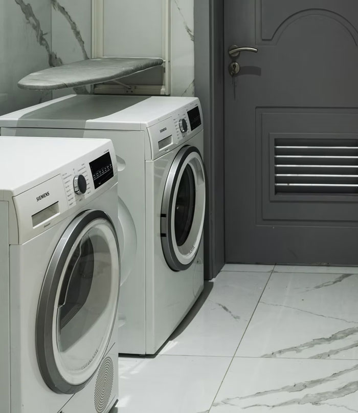 Laundry room with modern washer and dryer, highlighting annoying modern home trends in sleek minimalist design.