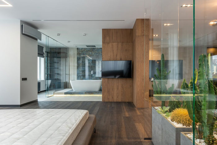 Modern home trends with glass walls and minimalist design blending bedroom and bathroom spaces, showing annoying features.