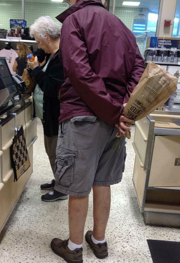 We Were In A Long Line At The Grocery. This Man Said He Had To Go Use The Restroom, But Instead He Secretly Bought Flowers For His Wife And Hid Them Behind His Back
