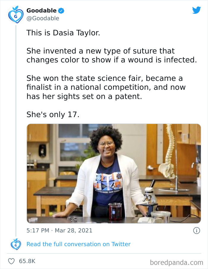 Young inventor in a science lab smiling proudly, showcasing a wound-detecting suture, a heartwarming wholesome internet story.