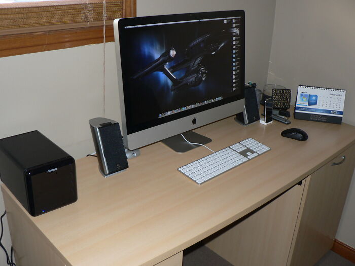 Modern office desk setup with computer and accessories, illustrating lawyers in online group sharing moments they knew people messed up.