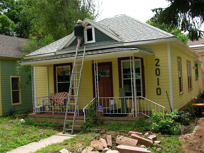 Person on a tall ladder inspecting a house roof, illustrating moments lawyers in online group shared about big mistakes.