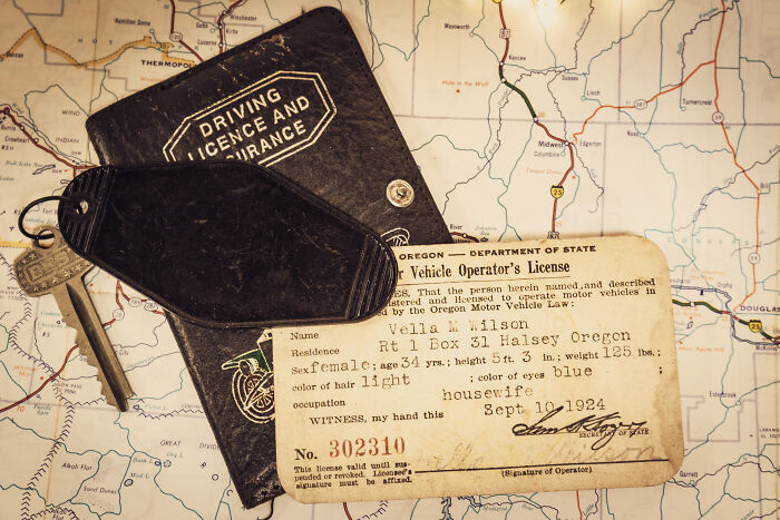 Old driving license and keys on a map, illustrating moments lawyers in online groups share about big mistakes.