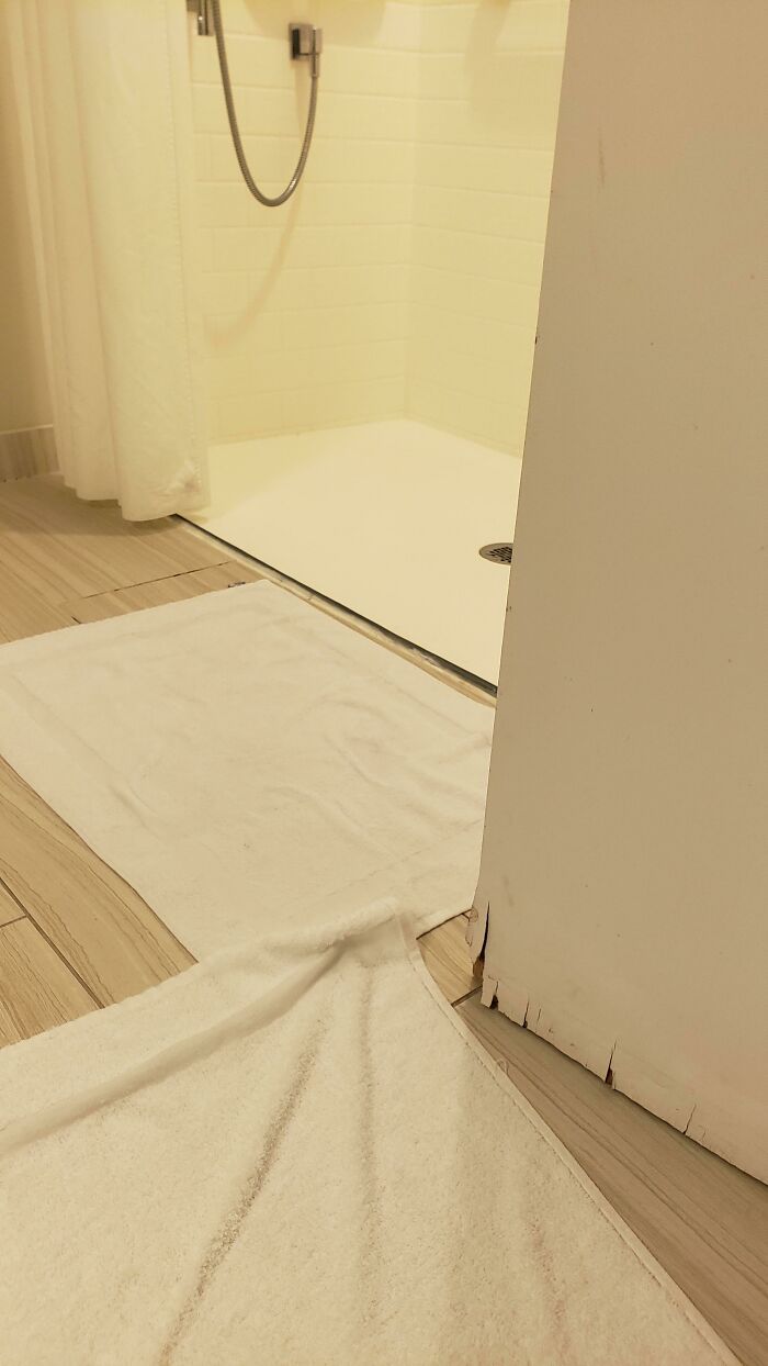 Hotel Shower Has No Edges So It Floods. Door Has Water Damage