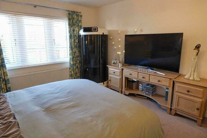 A White Cubicle With A Black Glass Screen And A Control Panel On Top