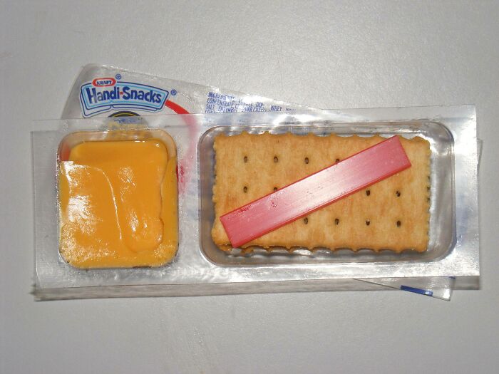 Handi-Snacks cheese and crackers, a nostalgic 90s food with red spreader on a plastic tray.