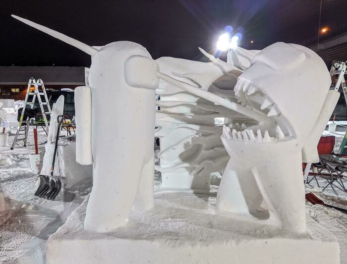 Snowman design featuring a creative duel scene with detailed snow sculptures and sharp snowman features at night.
