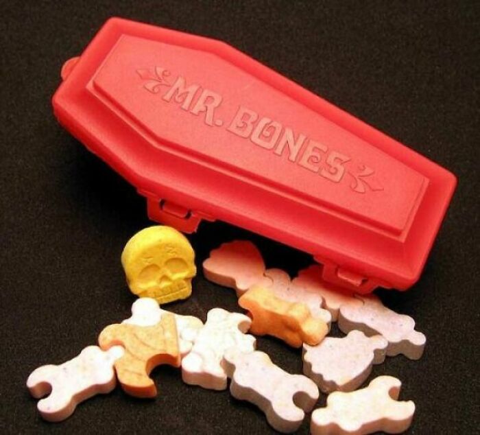 Coffin-shaped container with candy bones and skull, reminiscent of nostalgic 90s foods.