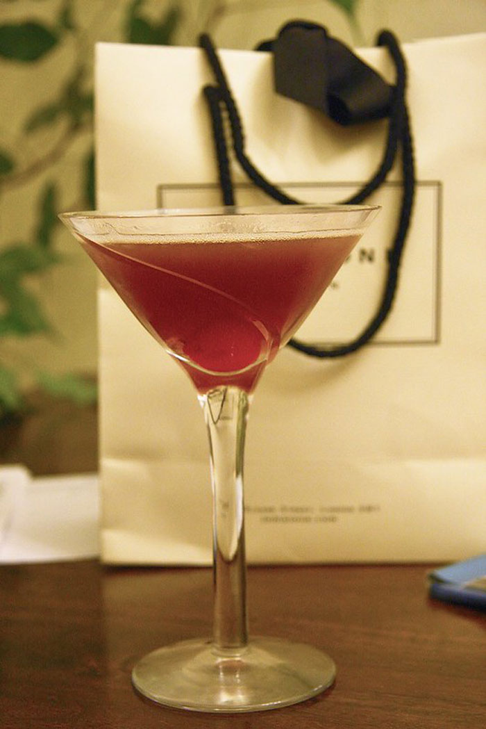 Cocktail in a martini glass with a cherry, symbolizing bartenders revealing drink orders and personality insights.
