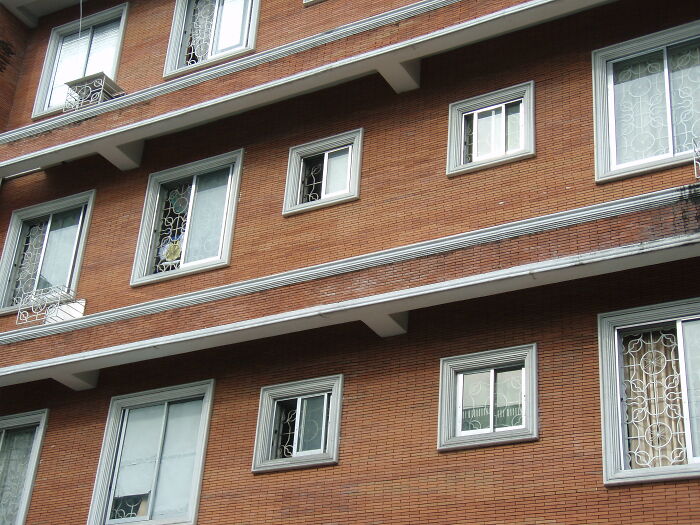 Exterior view of a multi-story building with windows, illustrating a setting where lawyers in an online group share stories.