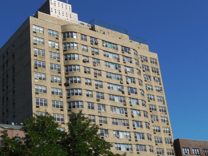 High-rise office building under clear blue sky, representing city scene for lawyers in online group discussions.