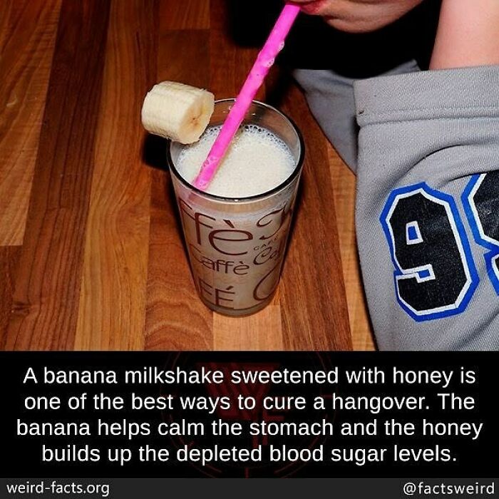 Glass of banana milkshake with pink straw and a banana slice, illustrating weird facts about the world and unique remedies.