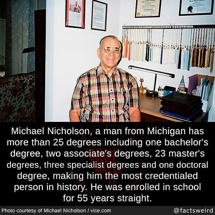 Man with over 25 degrees sitting at a desk, showcasing weird facts about the world and extreme educational achievements.