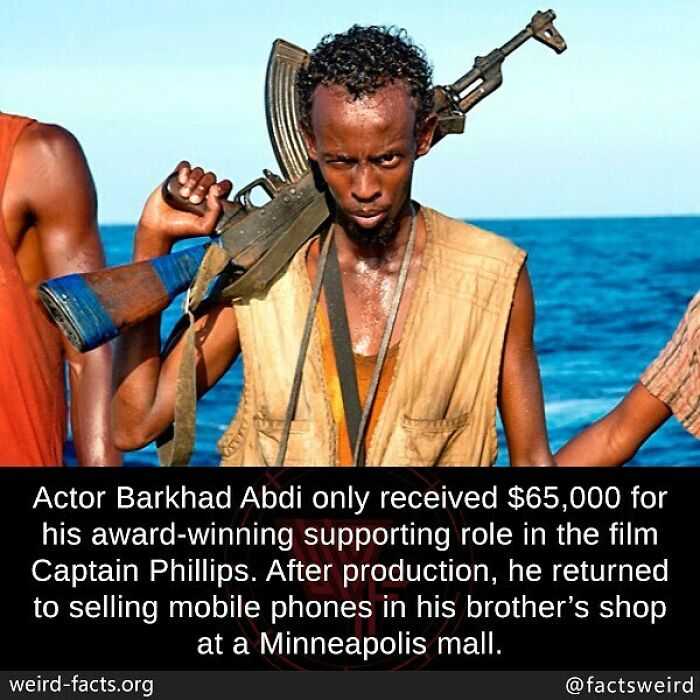 Man holding a rifle by the sea, illustrating one of the weird facts about the world that offer a fresh perspective.