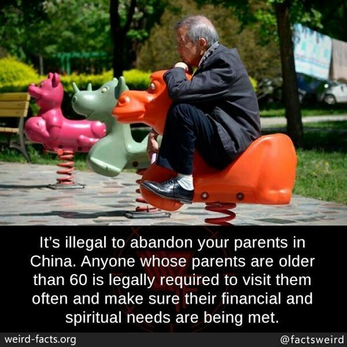 Elderly man sitting on orange playground spring rider in park illustrating weird facts about the world.