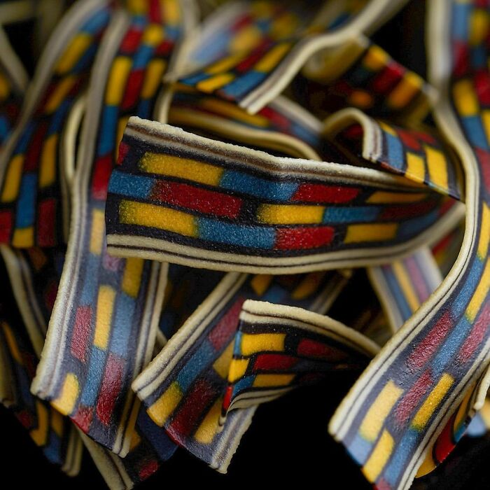 Close-up of unique pasta designs featuring colorful geometric patterns created by a chef, showcasing viral pasta art.