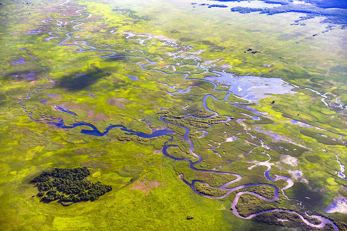 Aerial view of Poland featuring winding rivers and diverse green landscapes capturing the country's modern and interesting nature.
