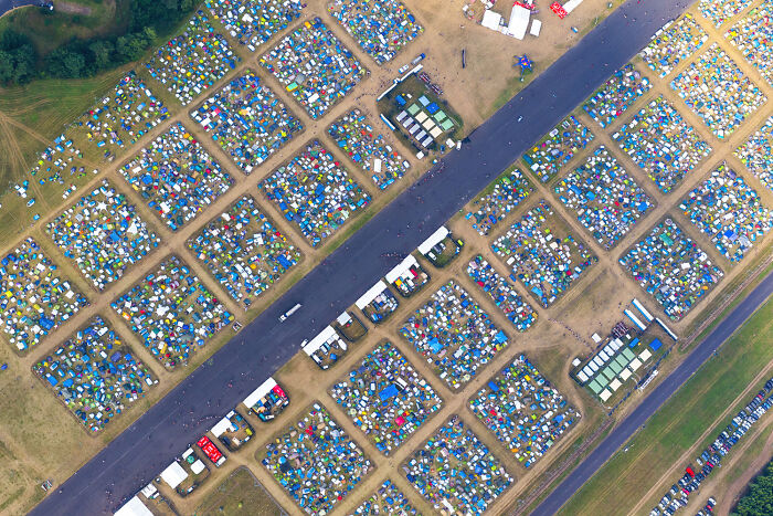 Aerial view of a large, organized campsite in Poland showcasing its modern, interesting, and diverse landscape.