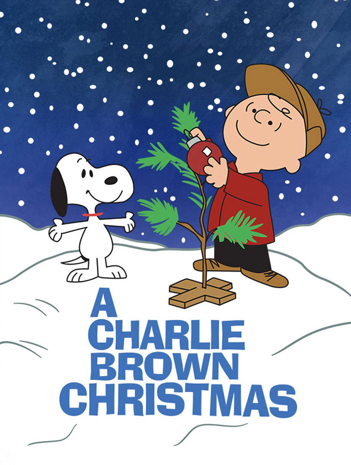 Charlie Brown decorates a small tree with Snoopy in the snow, typical of best Christmas movies.