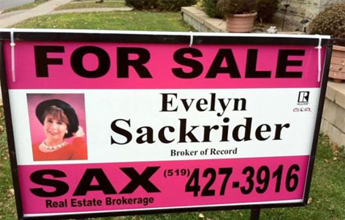 For sale real estate sign featuring agent Evelyn Sackrider with contact number, showcasing unusual names in the listing industry.